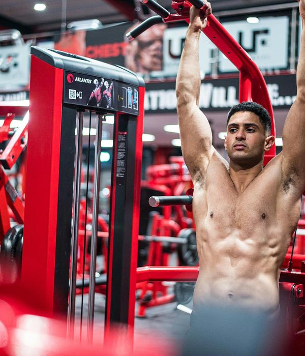 Man performing a core strength exercise in a bright, modern space.